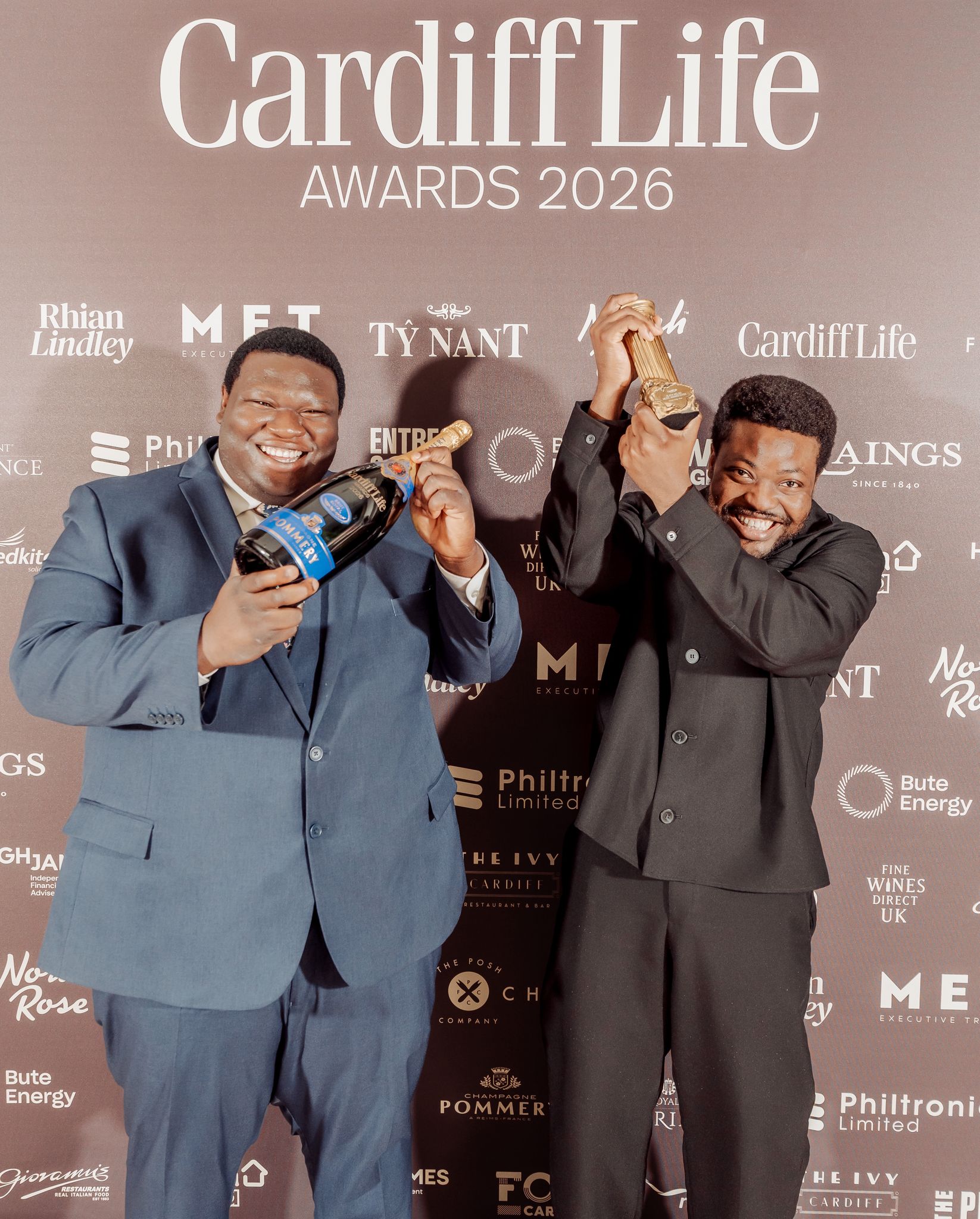 Graduates celebrating with award